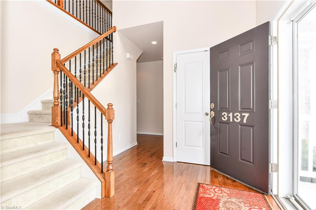 3137 Cranberry Ridge Drive High Point, NC 27265 - Photo 3 of 25 The two-story foyer also features a coat closet and stairwell with iron balusters.