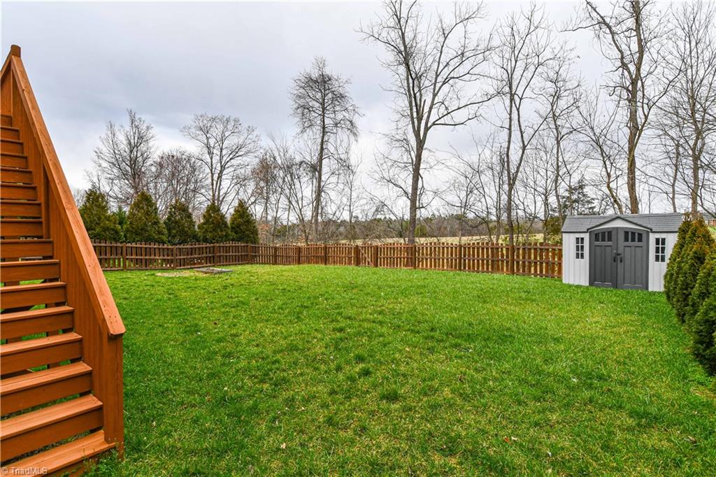 3137 Cranberry Ridge Drive High Point, NC 27265 - Photo 24 of 25 The backyard is fenced and features a storage building for storage.