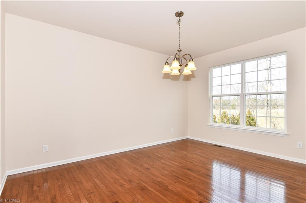 3137 Cranberry Ridge Drive High Point, NC 27265 - Photo 5 of 25 The formal dining room features hardwood flooring, two windows, and a chandelier.
