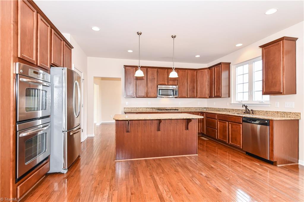 3137 Cranberry Ridge Drive High Point, NC 27265 - Photo 6 of 25 This cook's delight kitchen HAS IT ALL...features include recessed + pendant lighting, maple cabinets with granite counter-tops, SS appliances (double oven, built-in microwave, dishwasher, GAS RANGE, and refrigerator), eat-at island, and hardwood flooring.
