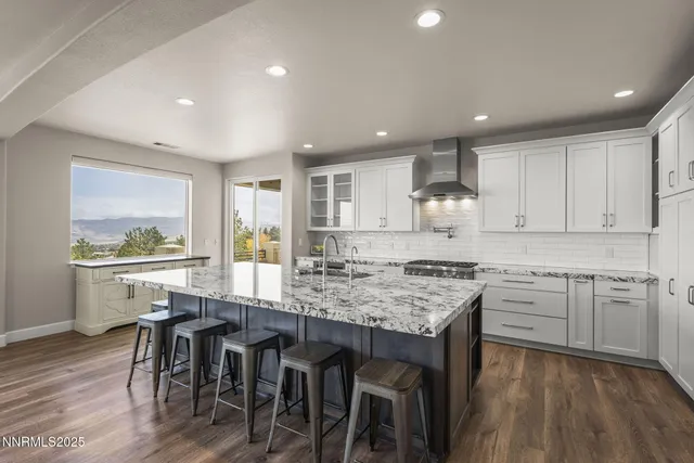 a kitchen with granite countertop a stove and a sink