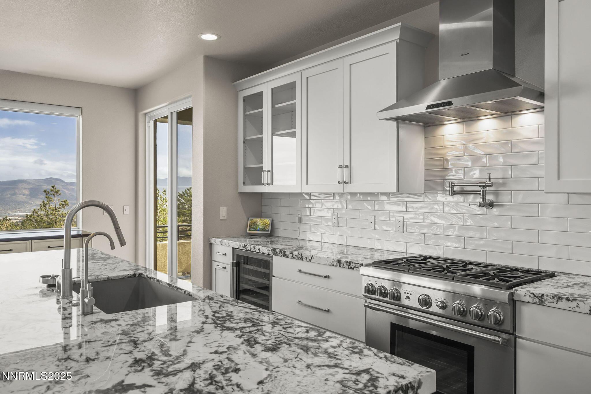 5640 Rue St Tropez Reno, NV 89511 - Photo 12 of 55 a kitchen with granite countertop a stove and a sink