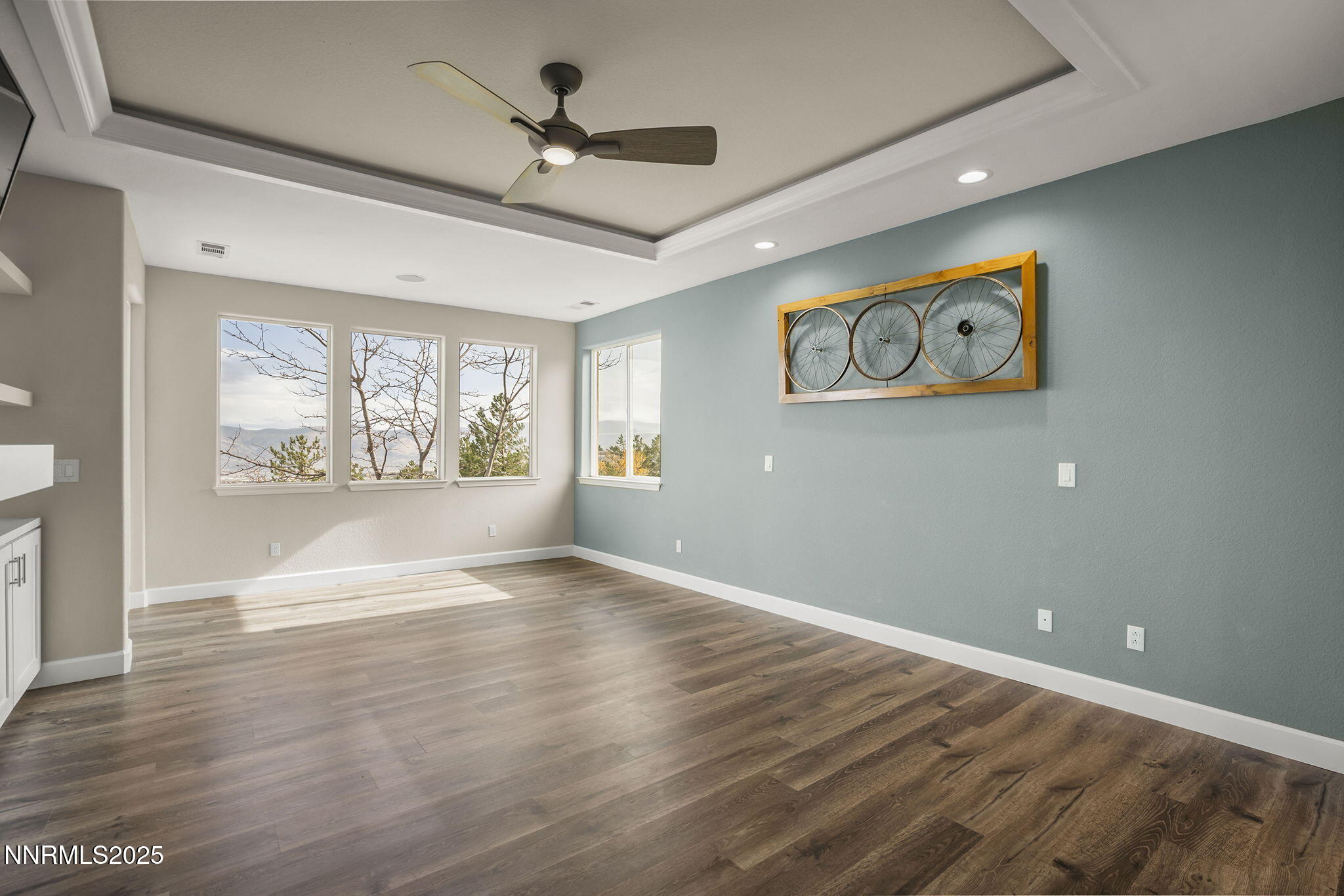 5640 Rue St Tropez Reno, NV 89511 - Photo 17 of 55 a view of an empty room with a window and wooden floor
