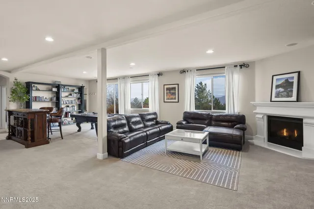 a living room with furniture pool table and a flat screen tv