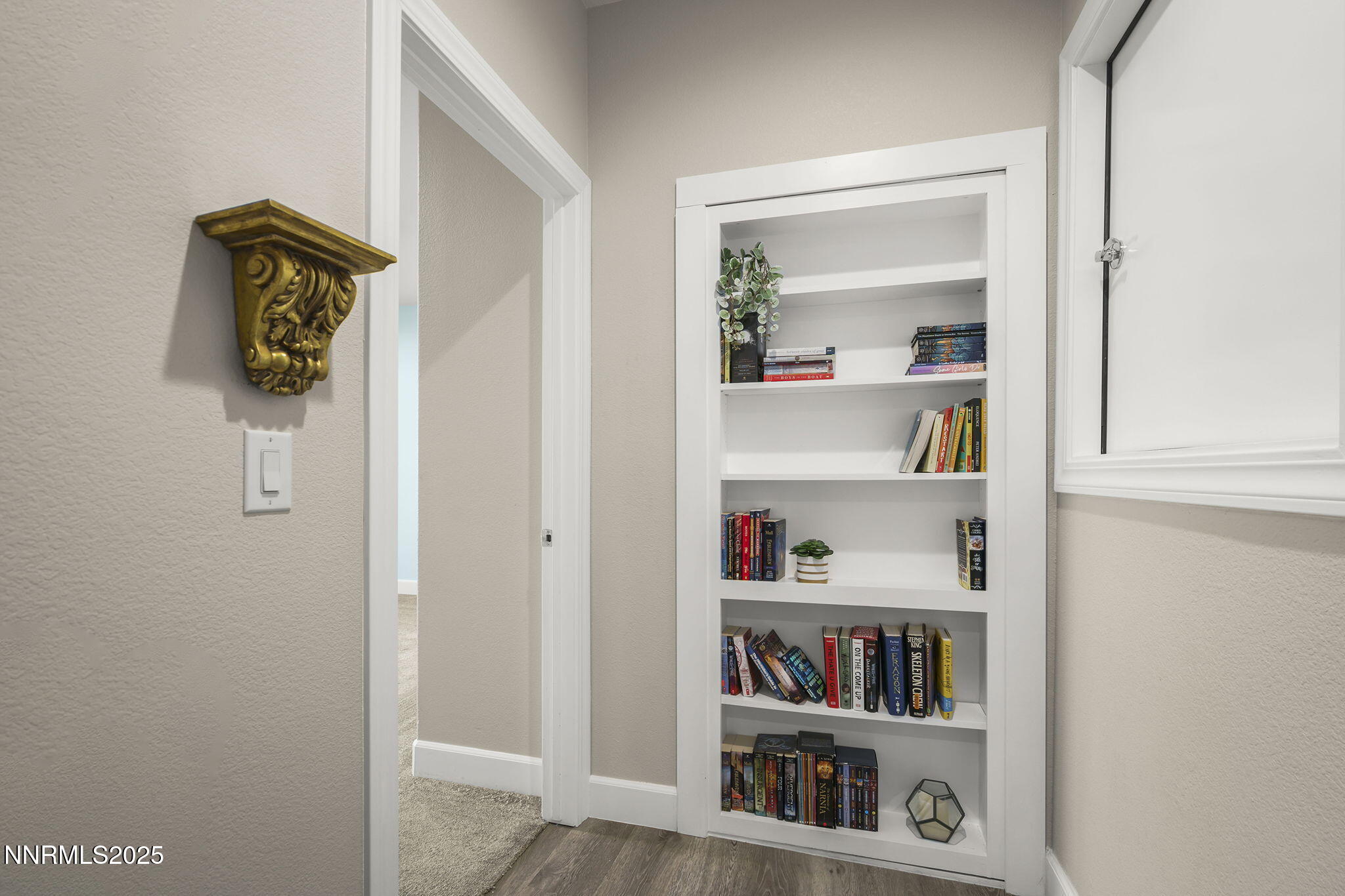 5640 Rue St Tropez Reno, NV 89511 - Photo 31 of 55 a shelf with books and knick knacks on it