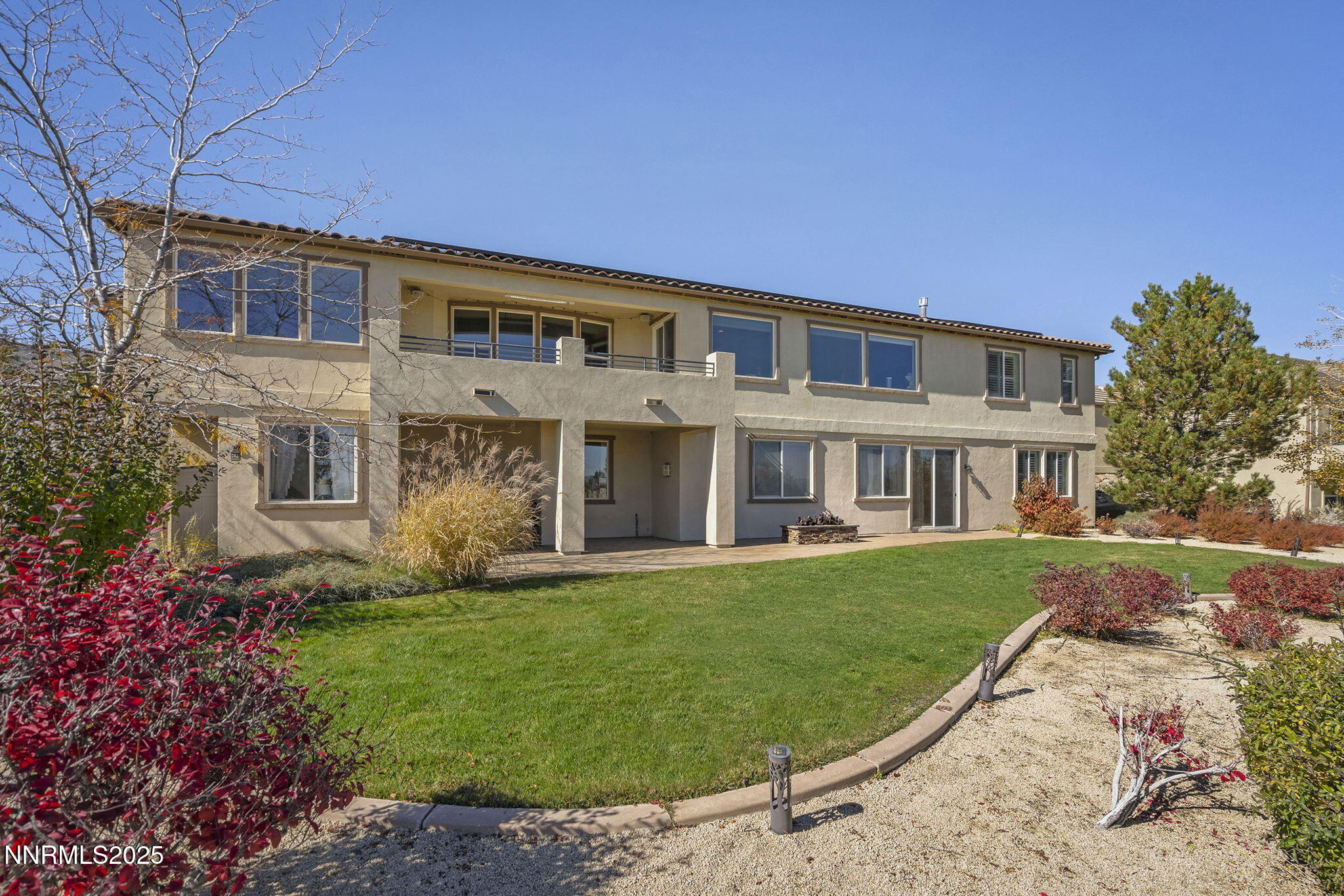 5640 Rue St Tropez Reno, NV 89511 - Photo 39 of 55 a front view of a house with a yard