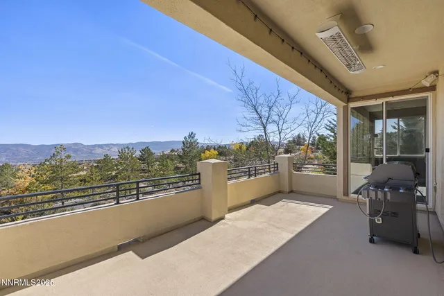 a view of a patio with table and chairs and wooden fence