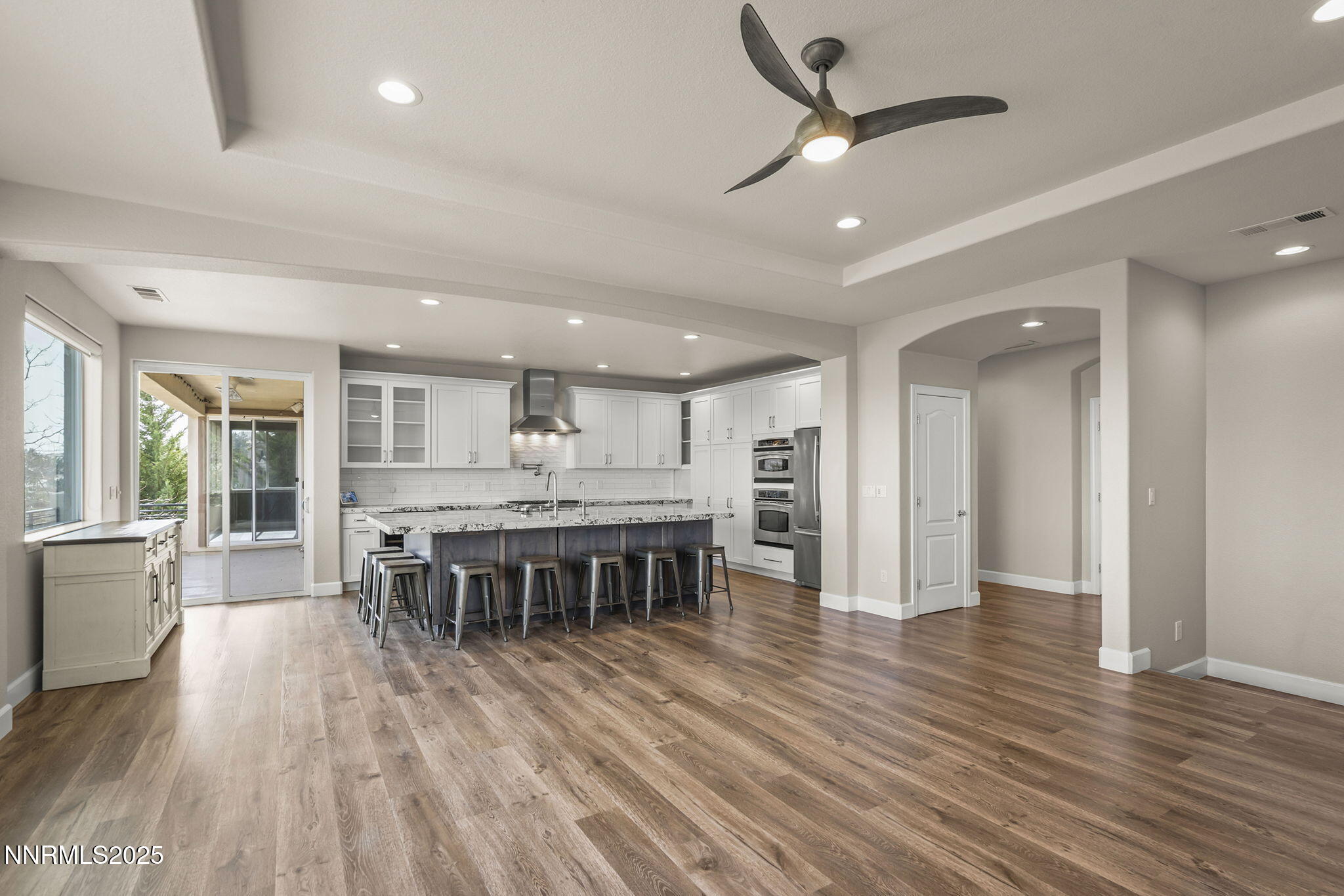 5640 Rue St Tropez Reno, NV 89511 - Photo 9 of 55 a dining hall with stainless steel appliances granite countertop a stove oven a refrigerator a dining table and chairs with wooden floor