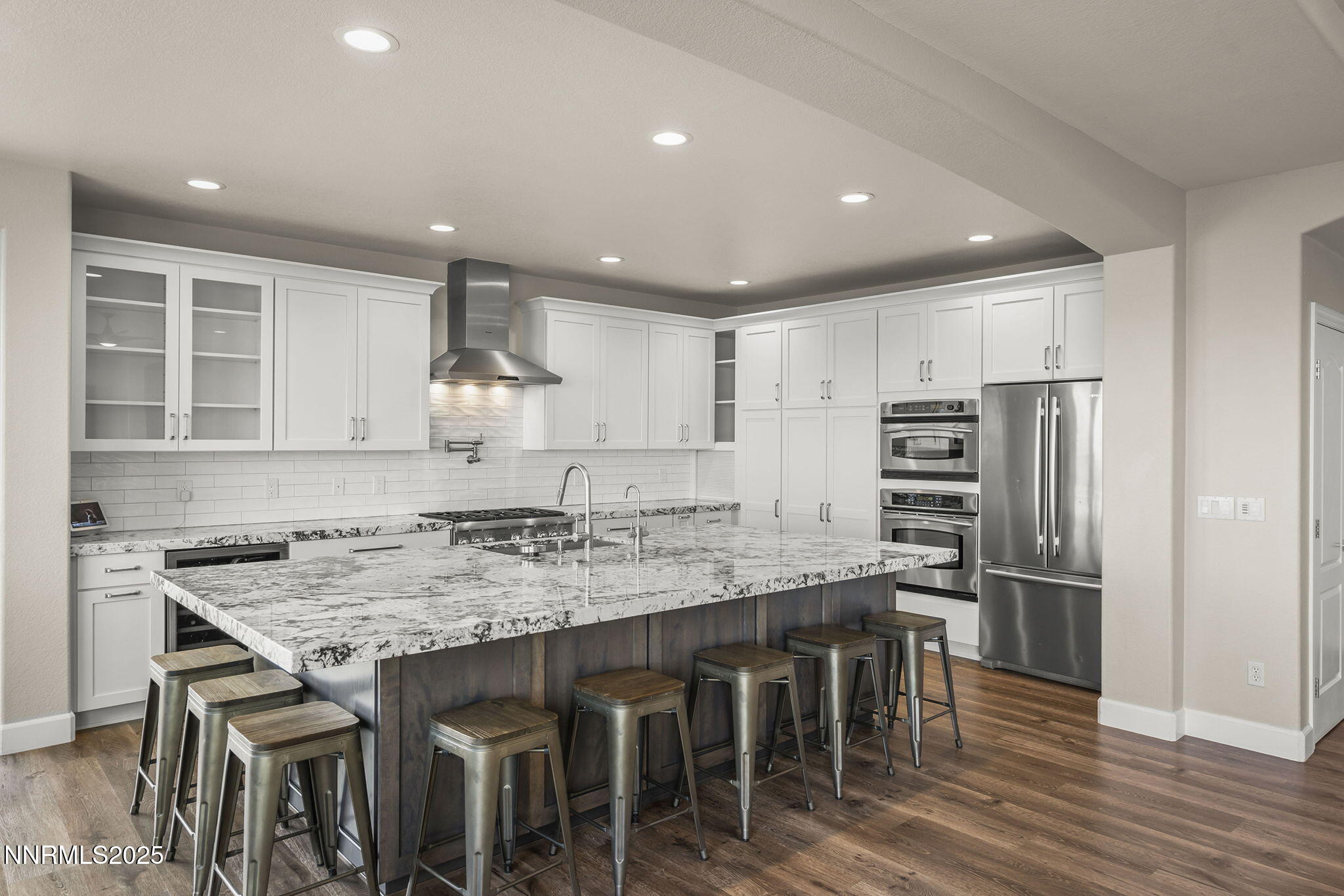 5640 Rue St Tropez Reno, NV 89511 - Photo 10 of 55 a kitchen with stainless steel appliances granite countertop a table chairs sink refrigerator and cabinets