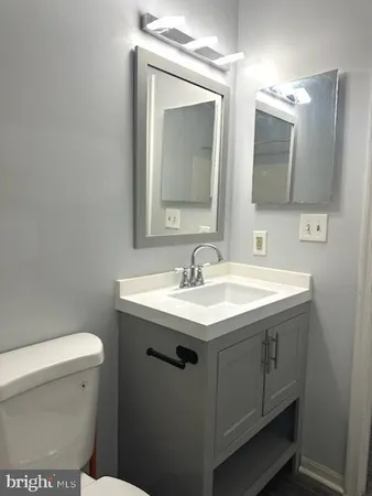 a white toilet sitting next to a bath tub