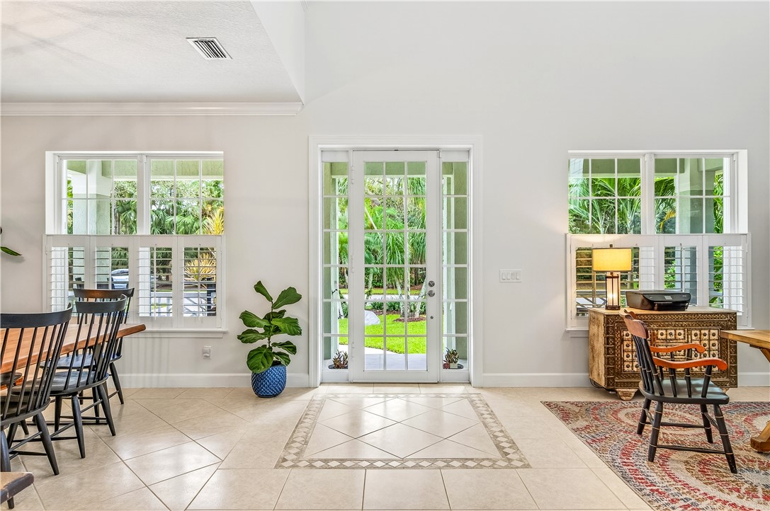 886 Carolina Circle Southwest Vero Beach, FL 32962 - Photo 16 of 36 a view of a dining room with furniture window and outside view