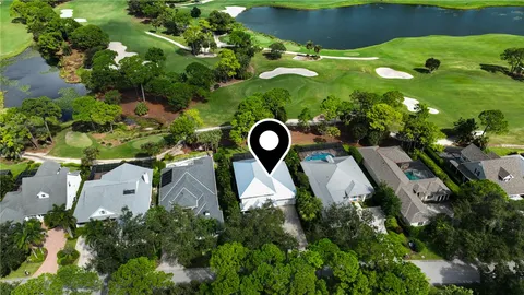 an aerial view of a house with a yard and outdoor seating