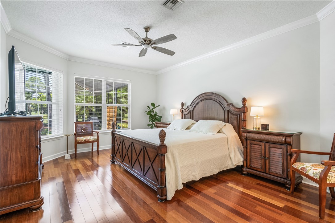886 Carolina Circle Southwest Vero Beach, FL 32962 - Photo 21 of 36 a bedroom with a bed and wooden floor