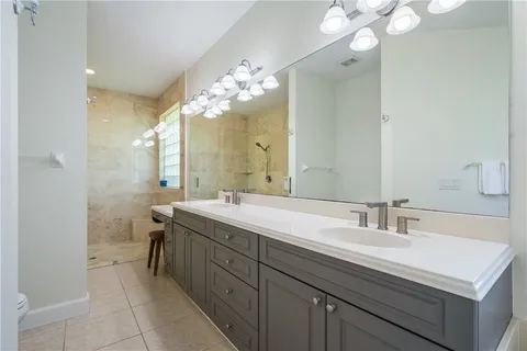 a bathroom with a sink double vanity and a mirror