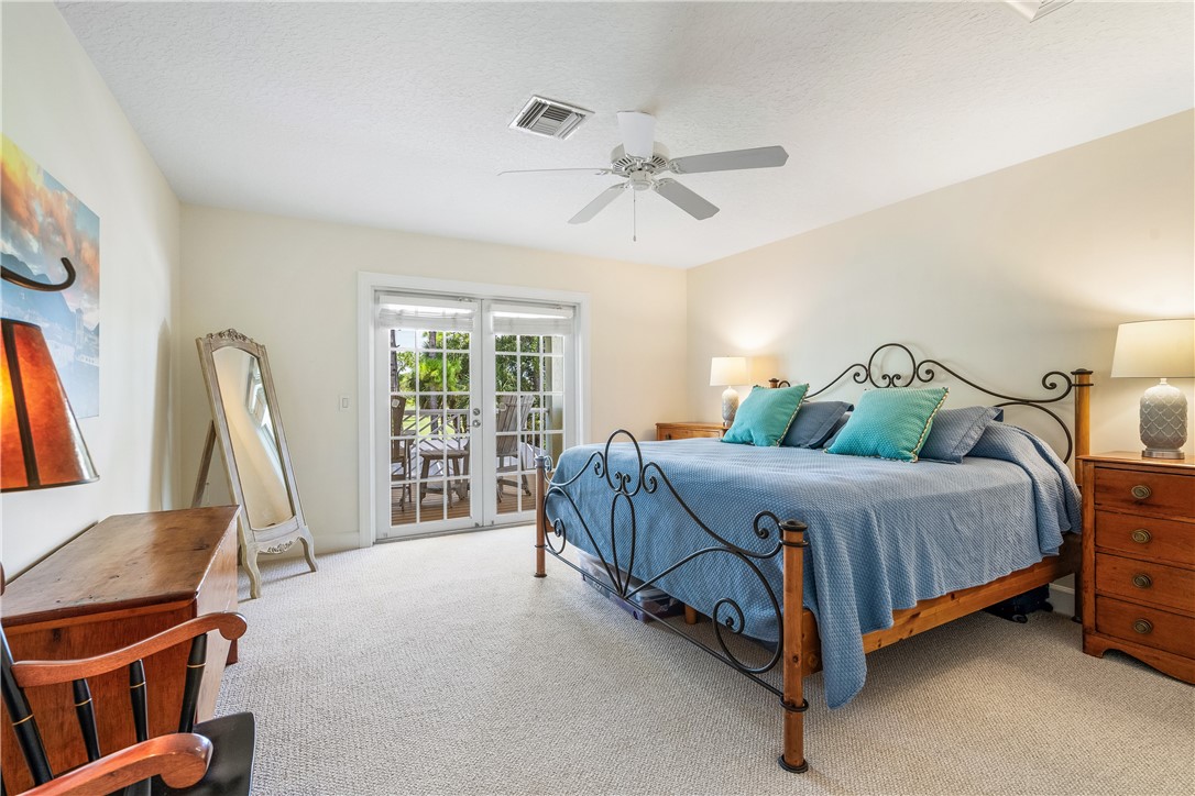 886 Carolina Circle Southwest Vero Beach, FL 32962 - Photo 23 of 36 a bedroom with a bed a couch and a window