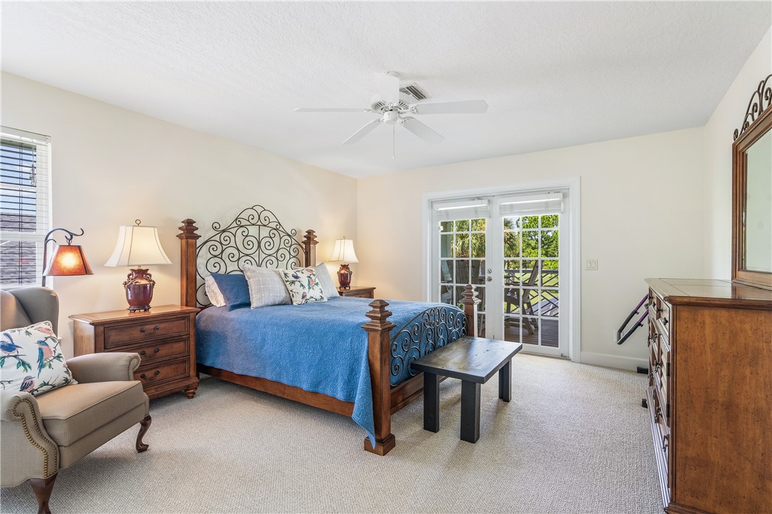 886 Carolina Circle Southwest Vero Beach, FL 32962 - Photo 24 of 36 a bedroom with furniture and a large window