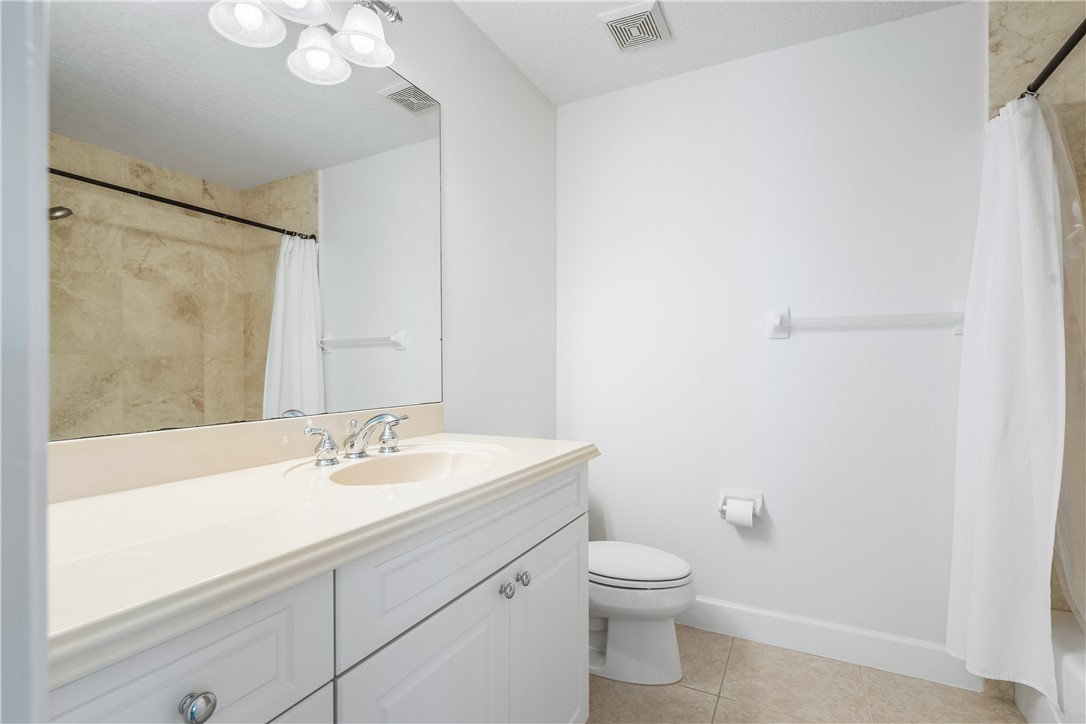 886 Carolina Circle Southwest Vero Beach, FL 32962 - Photo 25 of 36 a bathroom with a sink a toilet and shower