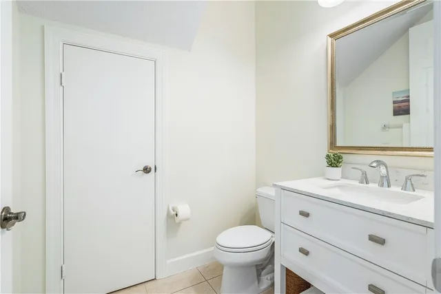 a bathroom with a sink a toilet a mirror and vanity