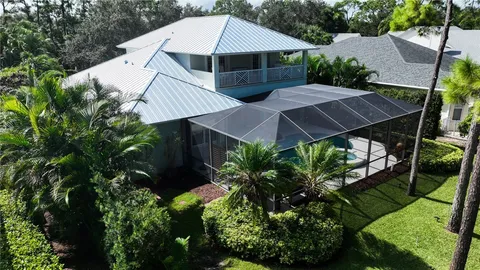 an aerial view of a house with yard and outdoor seating