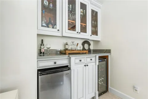 a kitchen with stainless steel appliances granite countertop a sink and cabinets with wooden floor