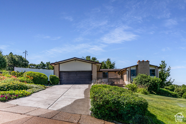 Undisclosed Address Farmington, UT 84025 - Photo 1 of 1 View of front of property with brick siding, a garage, and driveway