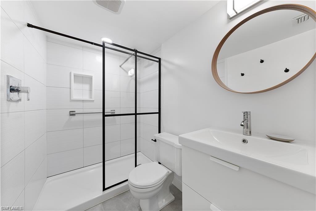 72 7th Street South, Unit 310 Naples, FL 34102 - Photo 19 of 24 a bathroom with a toilet sink and shower