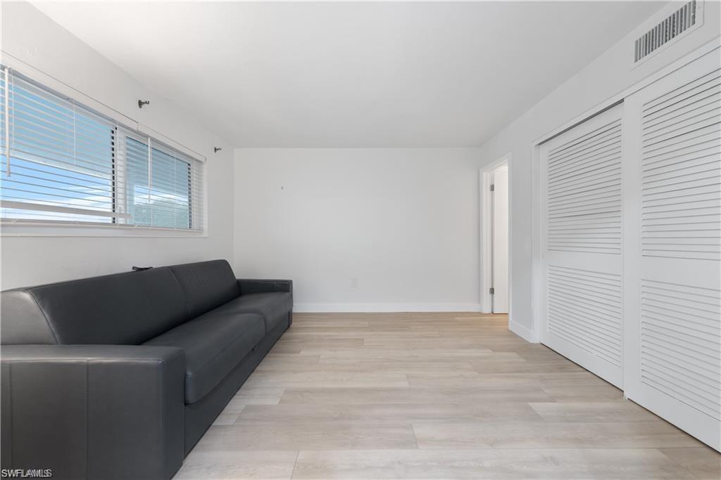 72 7th Street South, Unit 310 Naples, FL 34102 - Photo 20 of 24 a living room with furniture and a window