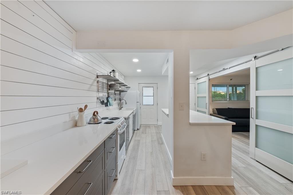 72 7th Street South, Unit 310 Naples, FL 34102 - Photo 3 of 24 a bathroom with a sink and a mirror