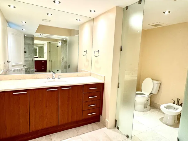 a bathroom with a double vanity sink mirror and toilet