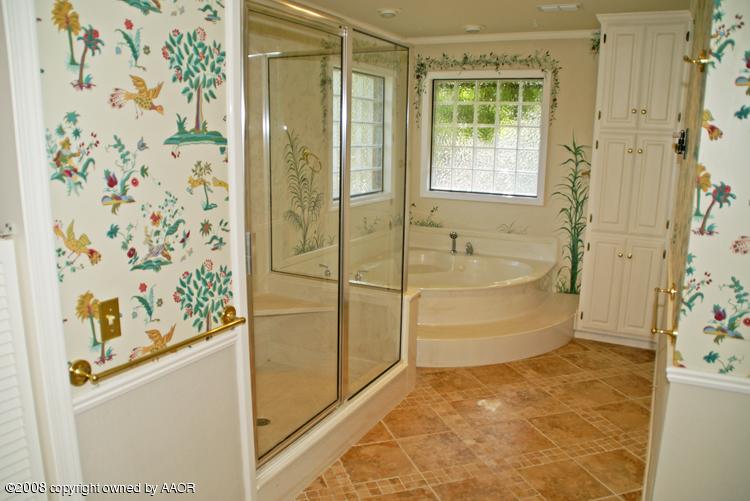 6910 Calumet Road Amarillo, TX 79106 - Photo 16 of 26 a bathroom with a bathtub and shower