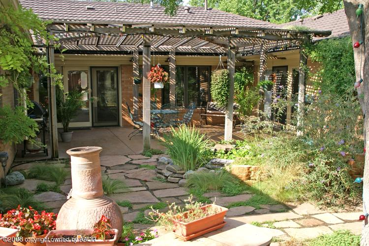 6910 Calumet Road Amarillo, TX 79106 - Photo 20 of 26 a view of a patio with table and chairs and potted plants