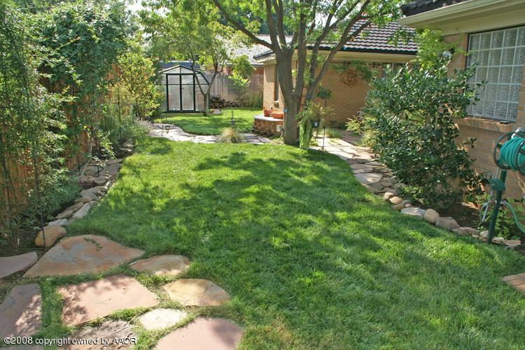 6910 Calumet Road Amarillo, TX 79106 - Photo 3 of 26 a backyard of a house with yard and outdoor seating
