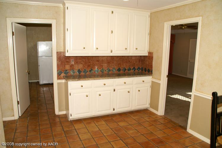 6910 Calumet Road Amarillo, TX 79106 - Photo 10 of 26 a view of a kitchen with white cabinets