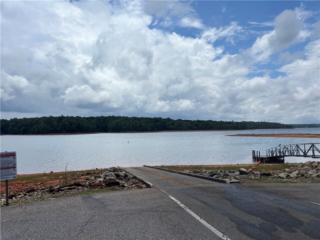 1901 Hattons Ford Road Townville, SC 29689 - Photo 30 of 33 Boasting a boat ramp and dock, this property offers direct water access under a dynamic sky.