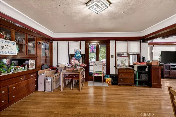 a living room with stainless steel appliances kitchen island granite countertop furniture and a flat screen tv