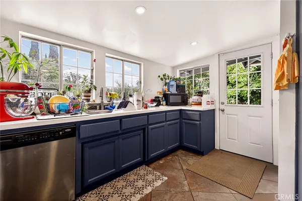 a kitchen with a refrigerator and a stove