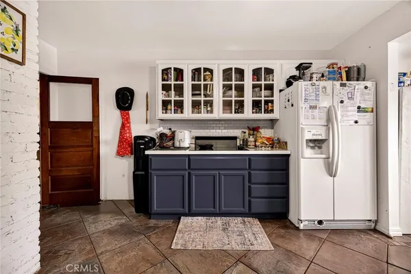 a kitchen with stainless steel appliances kitchen island granite countertop a refrigerator and a sink