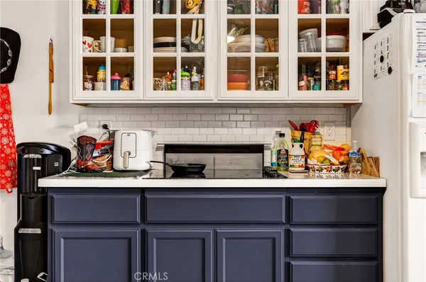 a view of a kitchen with fridge and workspace