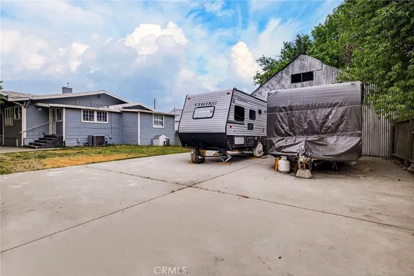a view of a house with a yard and sitting area
