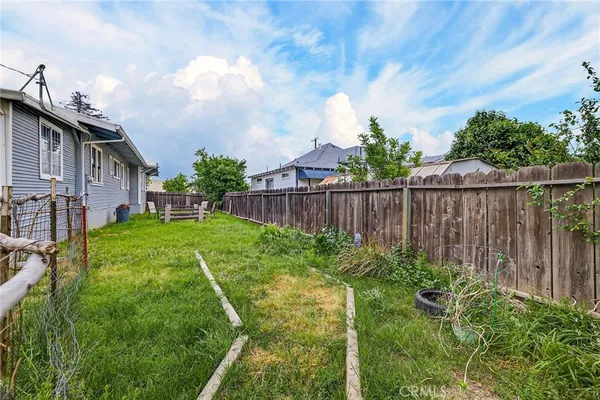 a backyard of a house with table and chairs