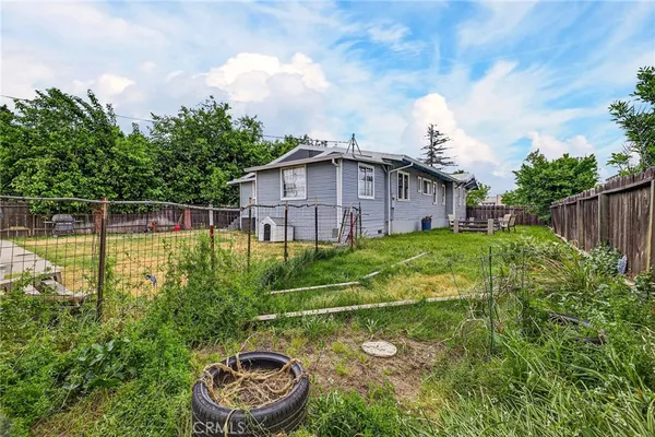 a view of house with backyard and trees
