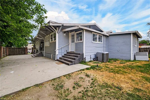 an aerial view of a house with garden space and street view