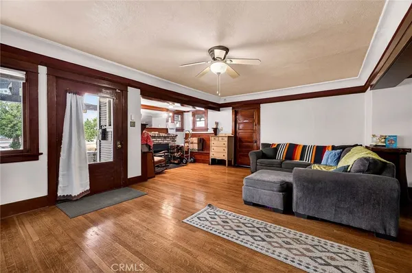 a living room with furniture and a floor to ceiling window