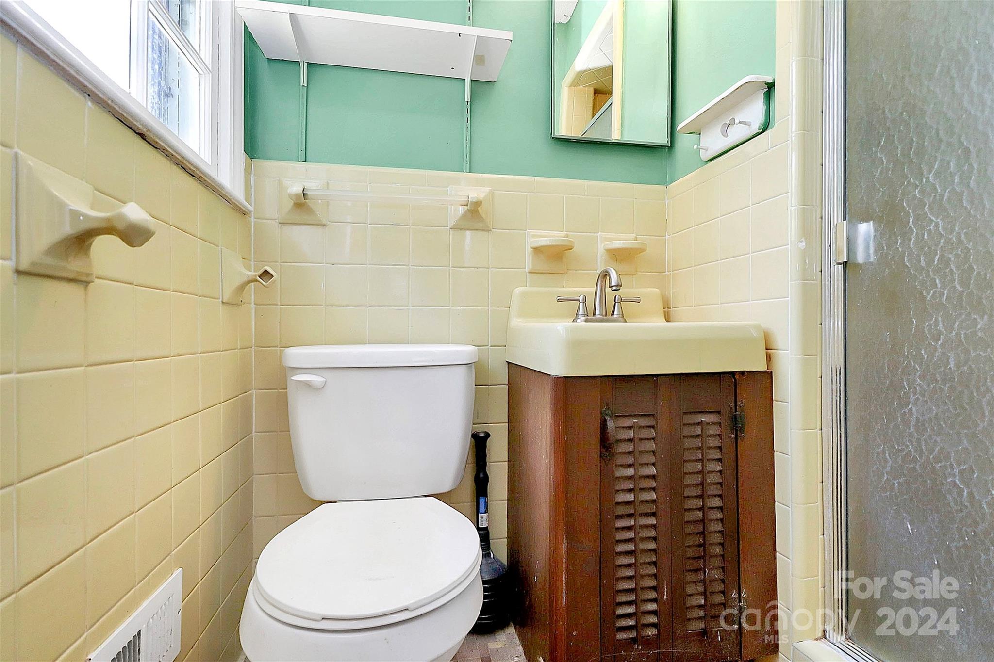 9811 Hannon Road Mint Hill, NC 28227 - Photo 18 of 27 a bathroom with a sink a toilet and shower