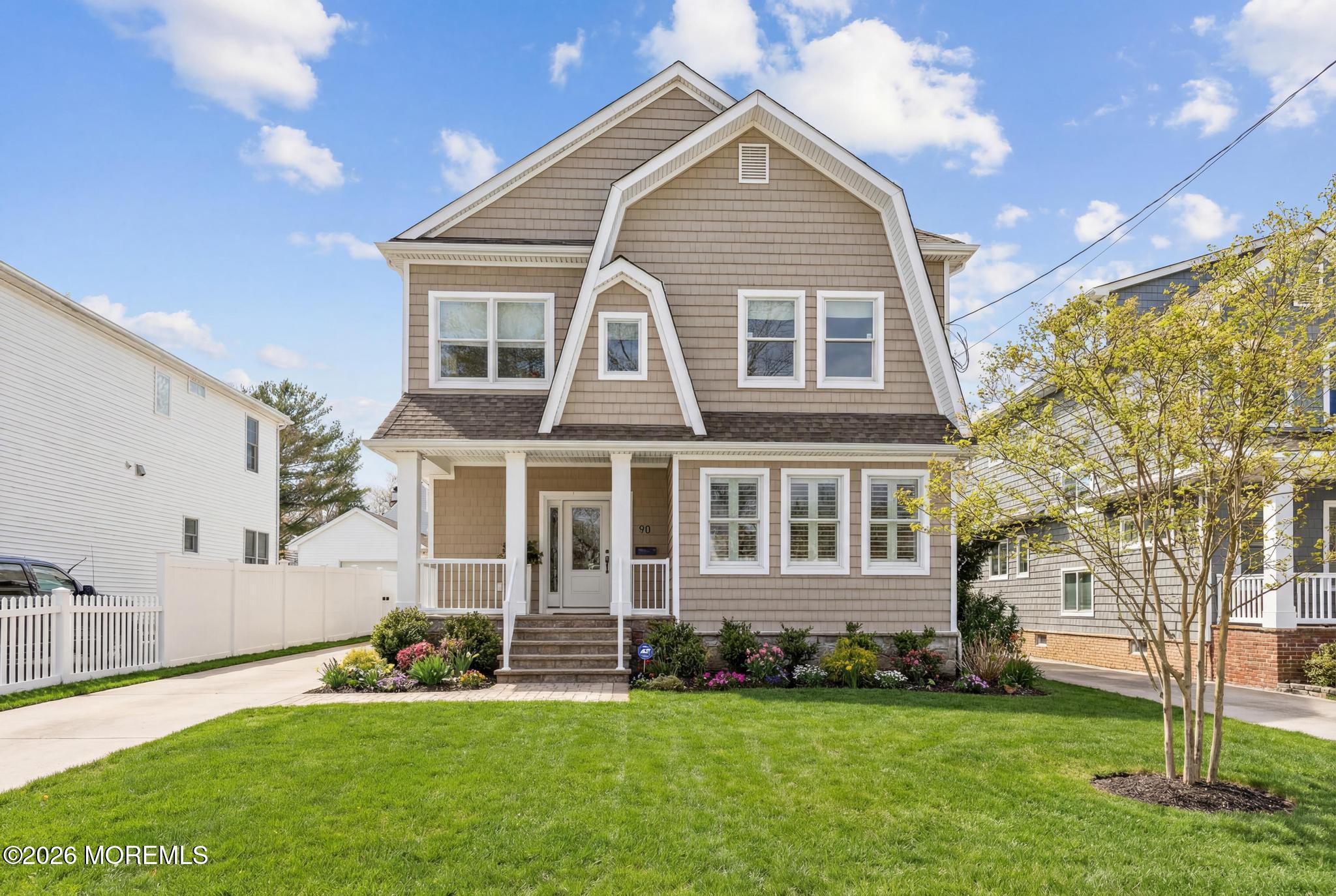 90 Washington Street Rumson, NJ 07760 - Photo 22 of 31 a front view of a house with a garden
