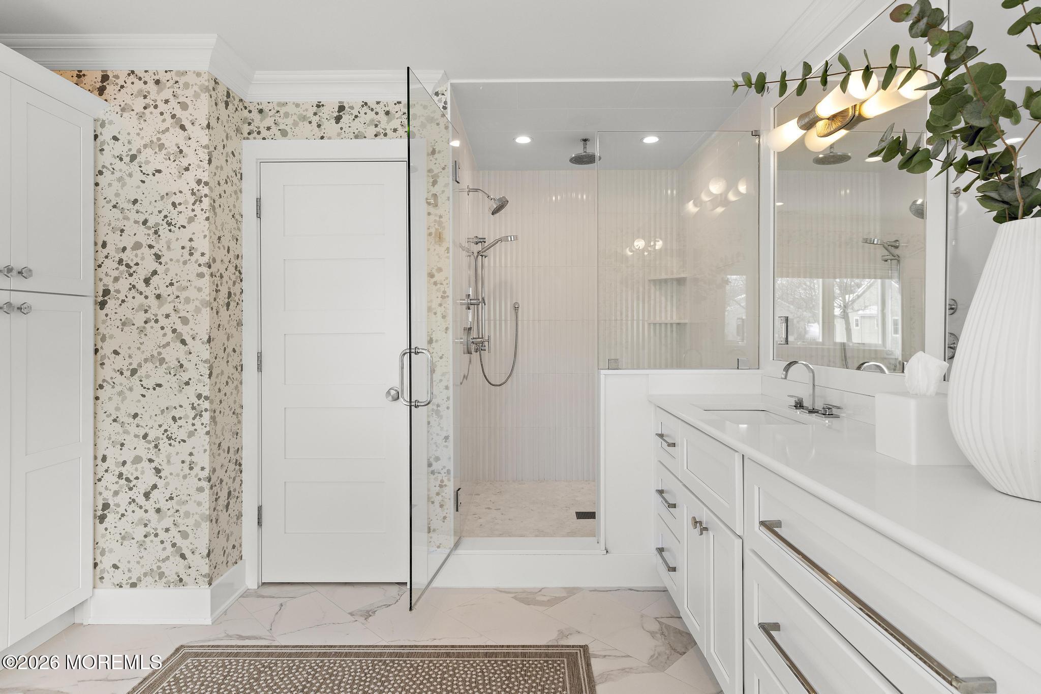 90 Washington Street Rumson, NJ 07760 - Photo 24 of 31 a spacious bathroom with a shower sink and mirror