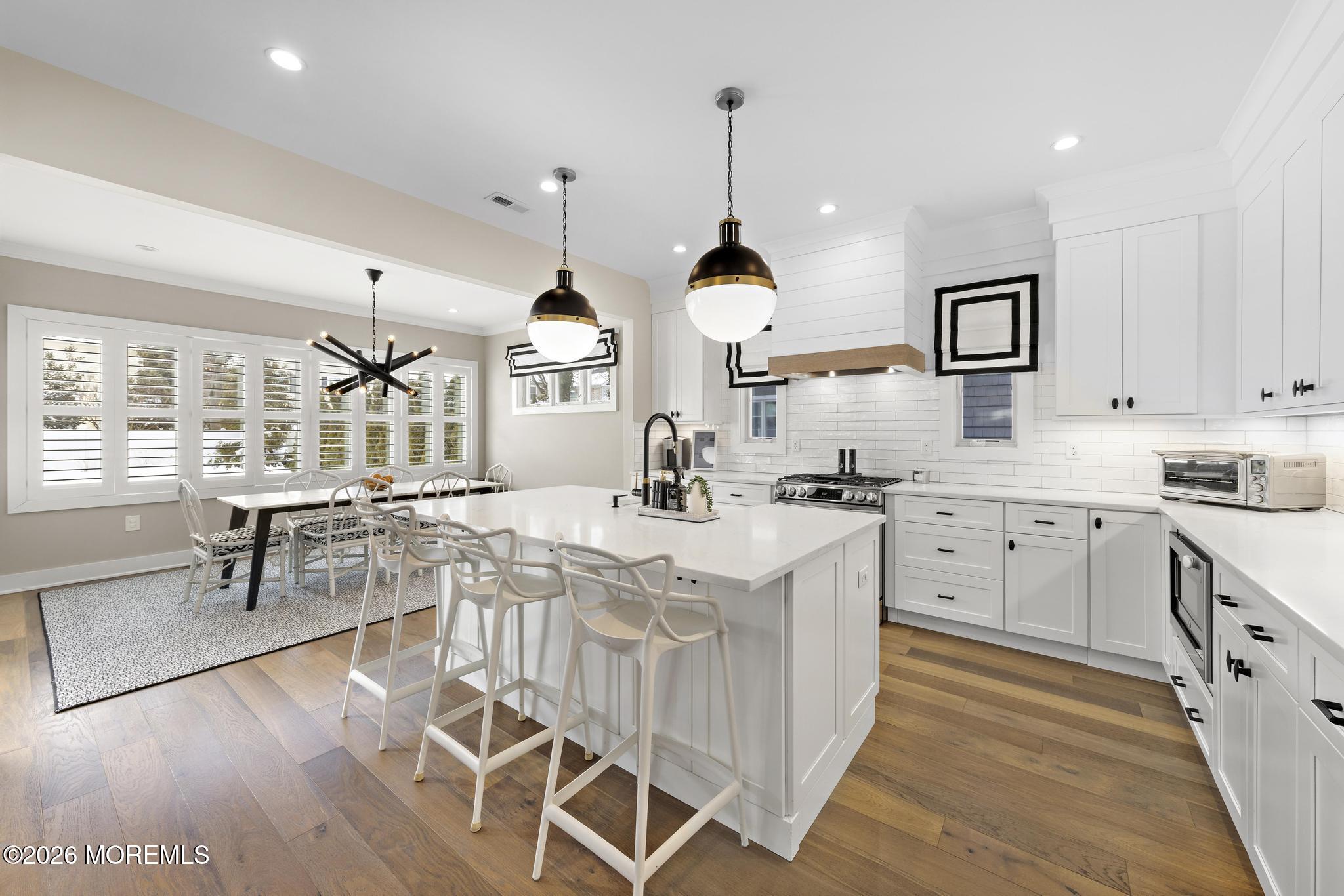 90 Washington Street Rumson, NJ 07760 - Photo 26 of 31 a kitchen with stainless steel appliances kitchen island granite countertop a sink a stove and a wooden floors