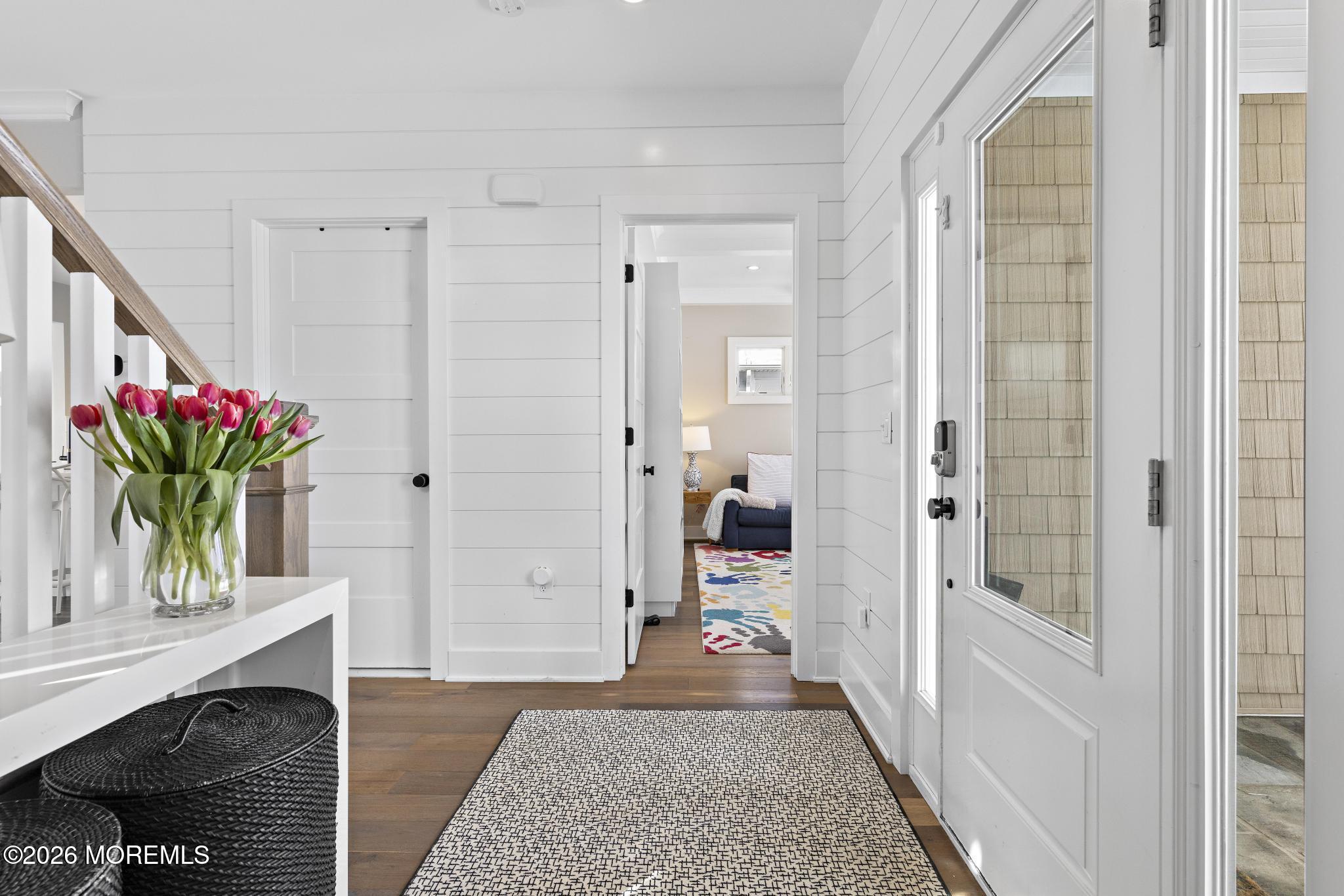 90 Washington Street Rumson, NJ 07760 - Photo 3 of 31 a hallway with painting on the wall and a fireplace