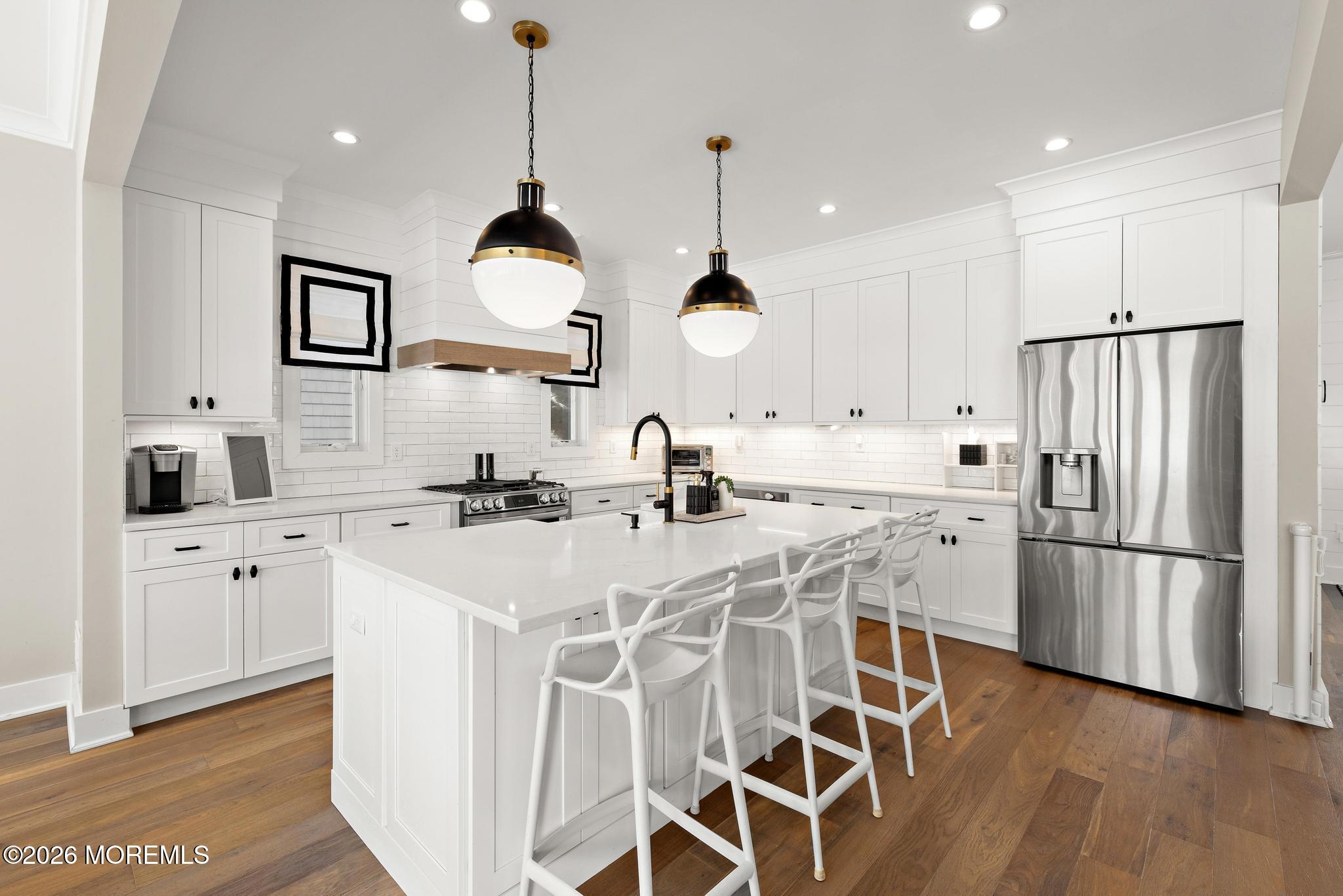 90 Washington Street Rumson, NJ 07760 - Photo 7 of 31 a kitchen with stainless steel appliances a stove a sink a refrigerator and cabinets