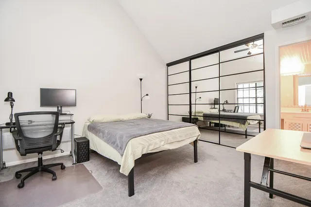 a bedroom with a bed window and a table